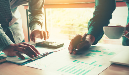 Business time in morning with two occupation adult asian young man doing workplace for finance analyzing and summary report on wooden desk.