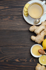 Ginger root tea with lemon and honey on wooden background, copy space