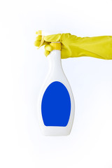 Hand in yellow glove holds spray  bottle of liquid detergent on white background. cleaning