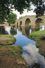 Fototapeta na wymiar Countryside, ancient bridge and river