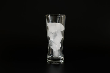 Closeup group of Ices in a glass over black background.