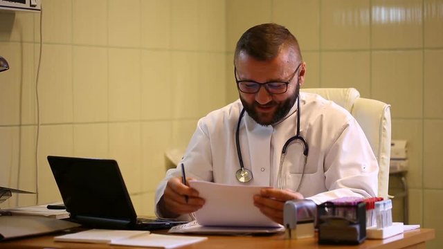 Doctor checking results in the office and telling good news to the camera

