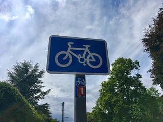 Blue Cyclist Sign With White Bike