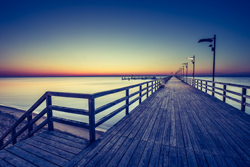 Amazing sunrise on the pier at the seaside. Gdynia Orlowo, Poland
