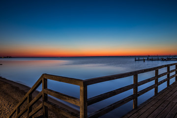 Fototapeta na wymiar Amazing sunrise on the pier at the seaside. Gdynia Orlowo, Poland