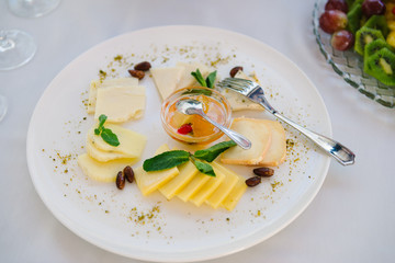 Cheese plate on the white cloth for the wedding reception and catering