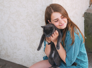 girl hugging a cat