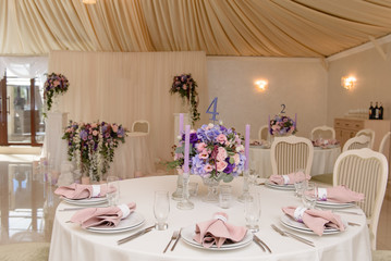 Wedding guest table decorated with bouquet and candles