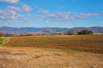Fototapeta na wymiar Ploughed field in spring prepared for sowing.