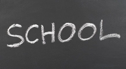 Obraz premium School written with chalk on blackboard.