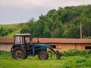 Tractor in green field. Nature background
