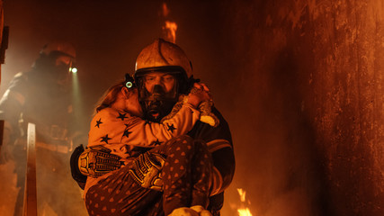 Brave Fireman Descends Stairs of a Burning Building and Holds Saved Girl in His Arms. Open fire and...