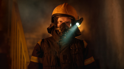 Portrait Shot of a Brave Fireman Standing in a Burning Building Fire Raging Behind Him. Open Flames...