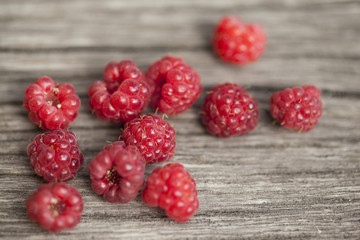 Raspberries on wooden background. Close up, top view, high resolution product.