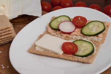 Whole grain healthy crunchy cereal bread with cheese and vegetables
