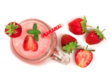 Glass of strawberry yogurt with mint leaves isolated on white background. Top view
