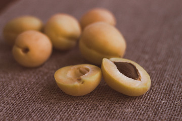 A few yellow apricots on the table. Summer fruits