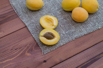 A few yellow apricots on the table. Summer fruits