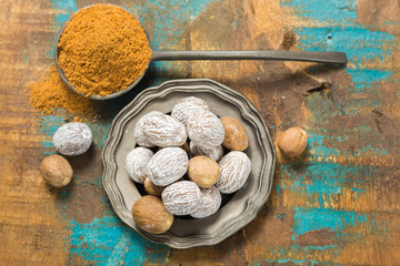 Nutmeg powder. Macro view whole nuts and grated muscat nuts.