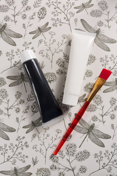 Colours in design, black and white  - home or office interieur design concept, tubes with acrylic paint and red brush