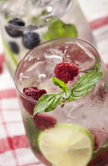 Summer cold drinks with raspberries, blackberries and blueberries on white background