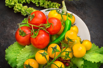 Set organic food. Fresh raw vegetables for salad. On a old black background. Top view. Close-up