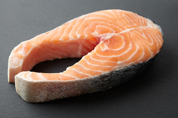 raw salmon steak, appetite fish on a dark background