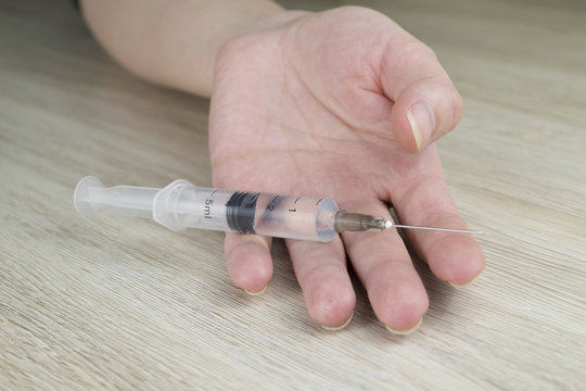 Medical syringe in a woman's hand
