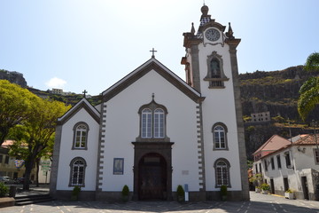 White church building with blue sky on coast of Madeira island, Portugal .