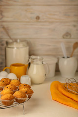 Kitchen utensils, tools and products for the capcake (muffins) on a light wooden background.