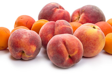 Heap ripe peaches and apricots