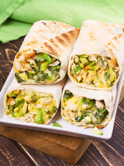 Chicken, avocado, cilantro and cheese burritos
