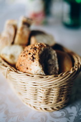 Fresh bread in basket. Slices roll breads in basket on table