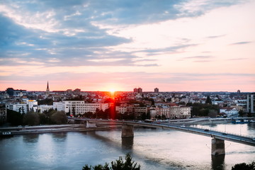 Beautiful sunset over Danube river and Novi Sad City with rainbow bridge
