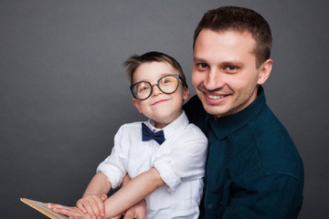 Smiling man with kid and book