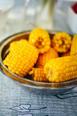 Plateful of fresh sweet organic corn steamed ready to eat. Prepared cooked sweet corn on the table