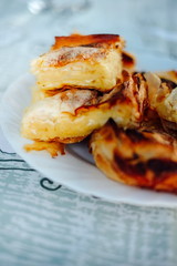 Pie with cheese - cheese pie in a white plate on the table.