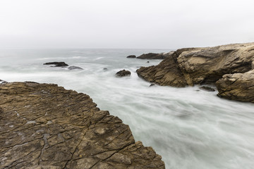 Motion blur sea water flowing from rocky cove at Leo Carrillo State Beach in Malibu, California.