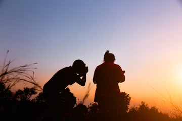 Women Nature photographer with digital camera on the mountain