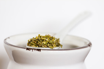 Origan on ceramic spoon