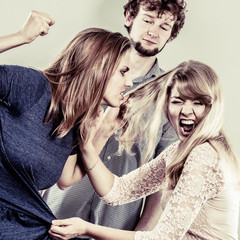 Aggressive mad women fighting over man.