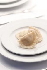 Dumplings made of water served in luxury restaurant at white plate.