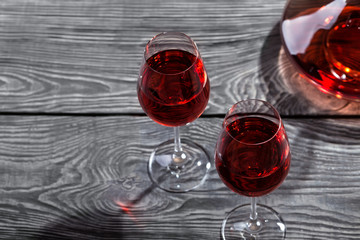 Decanter and two glasses of red wine on a wooden table