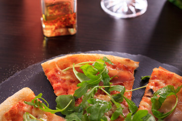 Pizza served in stone plate on restaurant.