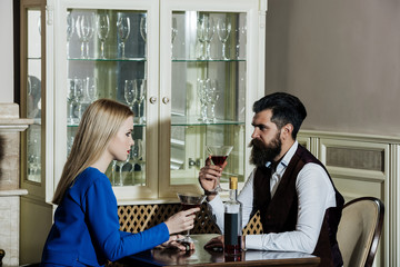 Girlfriend and boyfriend drinking red wine in restaurant