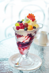 Delicate berry cream dessert in a kremanka on a table in a cafe