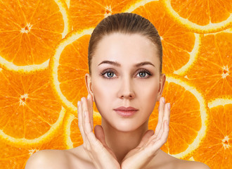 Young woman over orange fruit slices background.