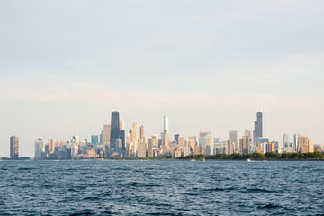 Hazy view of the Chicago skyline with Lake Michigan in the foreground