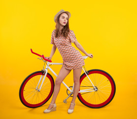 Fototapeta na wymiar Confident stylish girl with retro bicycle