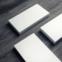 Photo of blank business cards on a wooden background. Template for ID. Business cards mockup.